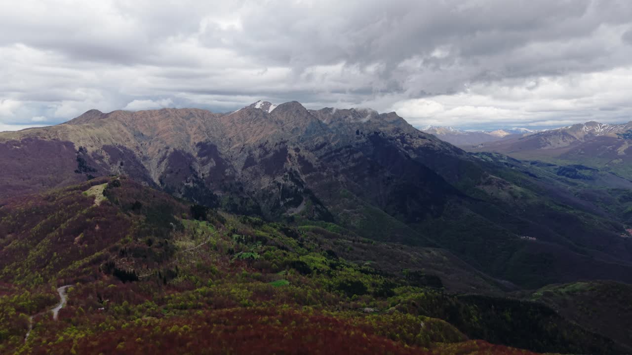 Old radar dome on remote mountain peak, aerial view with moody spring atmosphere