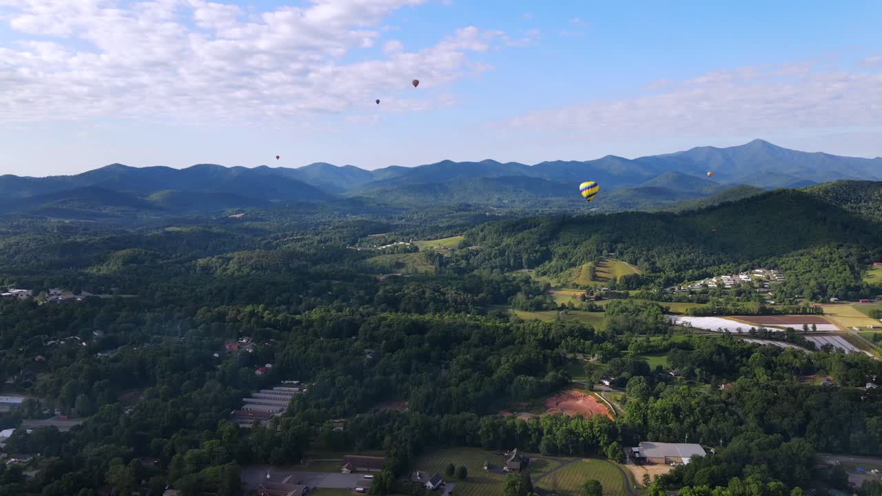 una excelente toma aérea de globos aerostáticos sobrevolando asheville, carolina del norte