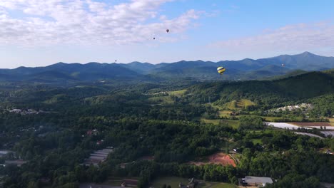 una excelente toma aérea de globos aerostáticos sobrevolando asheville, carolina del norte