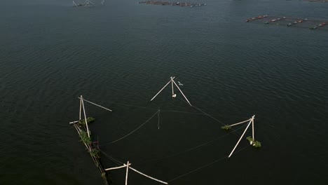 aerial view of fishing nets and fish farms on a lake
