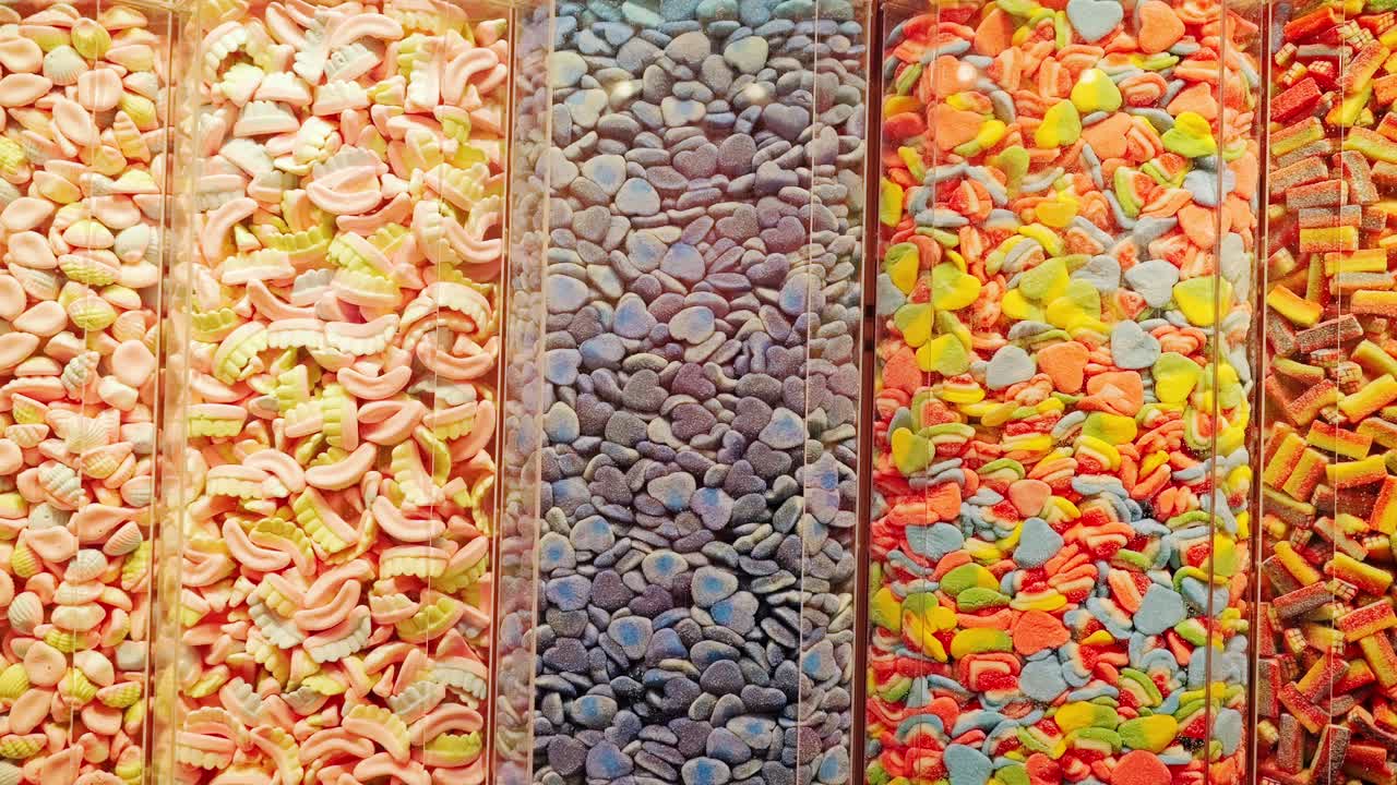Rows of colorful candies symbolize childhood joy, indulgence and abundance