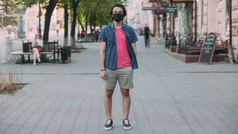 Man wearing a mask on a city street