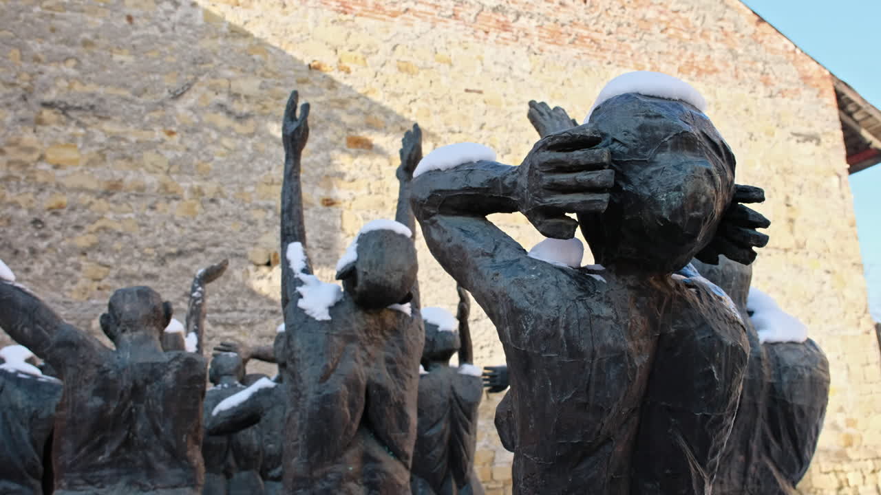 Memorial to the victims of communism and resistance metal statues in Sighetu Marmatiei in winter, snow, Romania