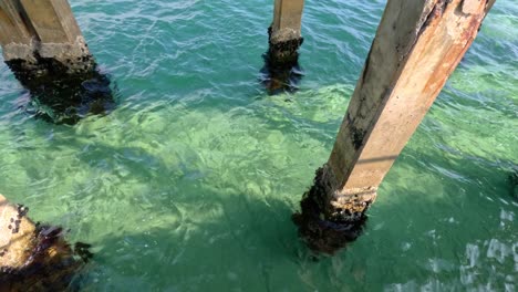 waves moving around pier pillars