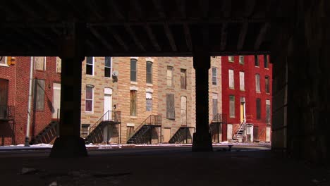 tenements houses under an overpass in an american city