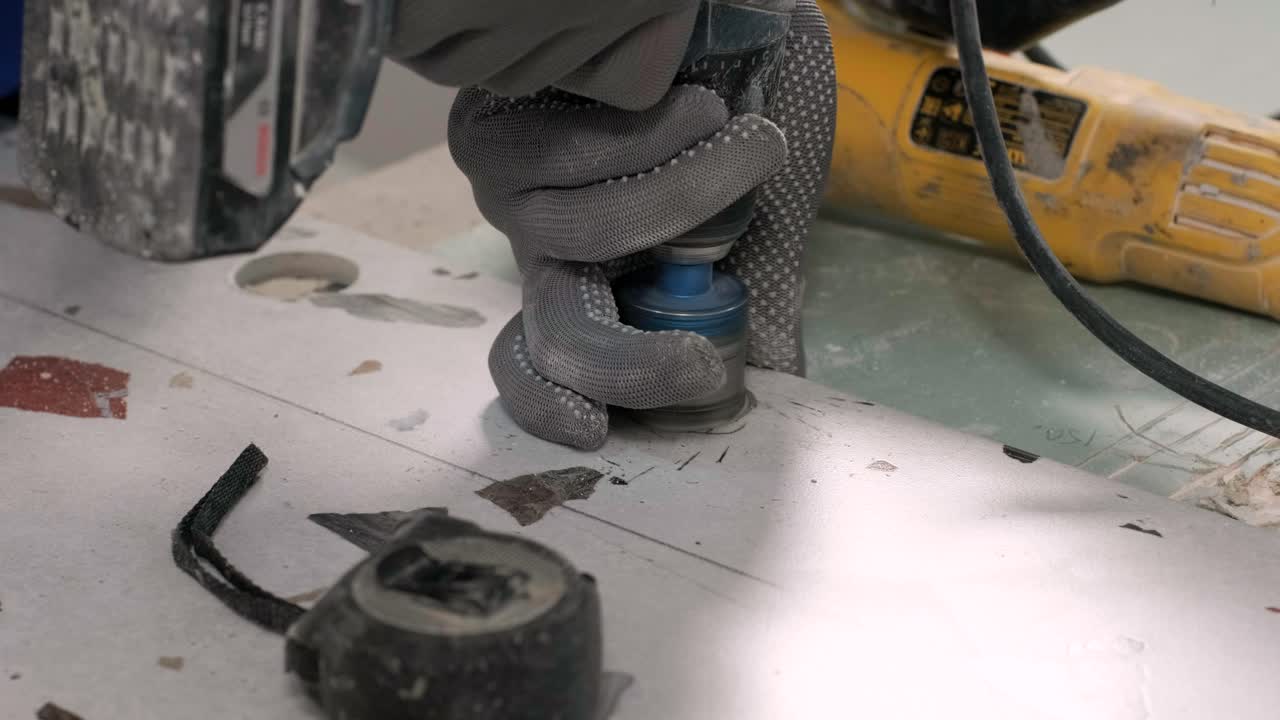 Installing ceramic floor tiles - measuring and cutting the pieces. Construction, renovation, repair apartment. Cuts tile. Tile cutting