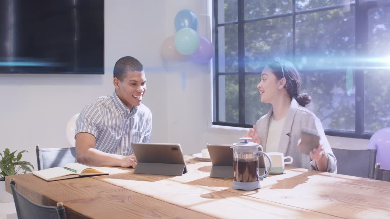 Man tapping tablet starting animated charts floating toward woman, both collaborating for business