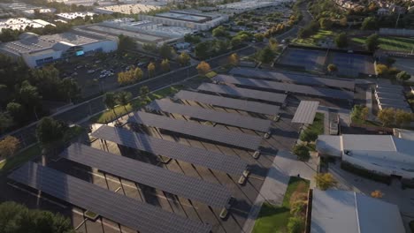 solar panels used as covered parking at a progressive high school - aerial orbit as sun shines down