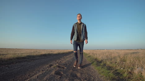 man walking on country road