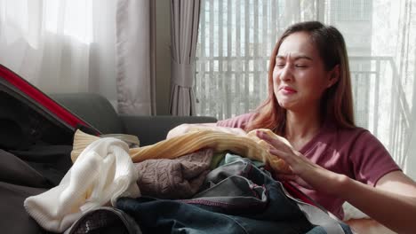 cute woman folded clothes and packed a suitcase to happily prepare for a trip