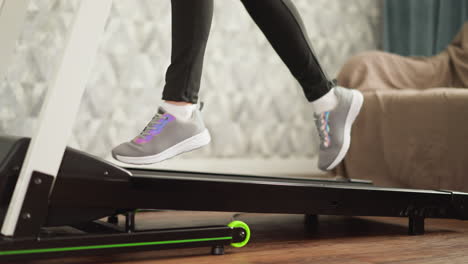 woman running on treadmill at home