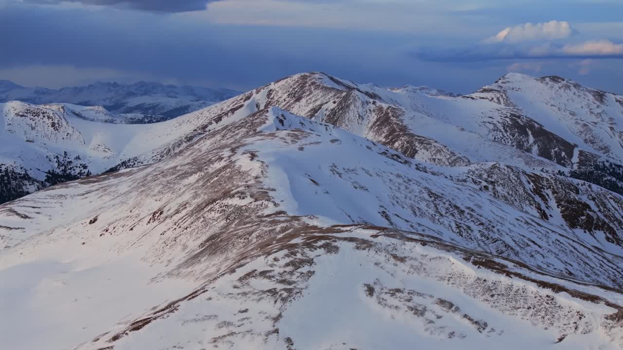 Coon Hill Eisenhower Tunnel Loveland Pass Continental Divide Loveland Ski area cornice aerial drone Colorado snow capped peaks golden hour sunset clouds skiing backcountry terrain forward pan up