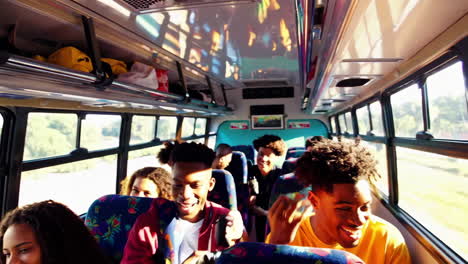 a diverse group of young people enjoying a lively bus ride