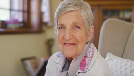 senior woman on sofa thinking about happy memory