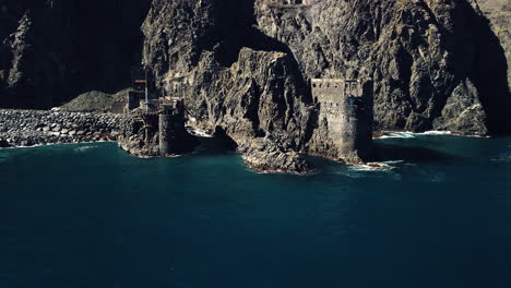 coastline buildings drone shot on a sunny day in the canary island, la gomera