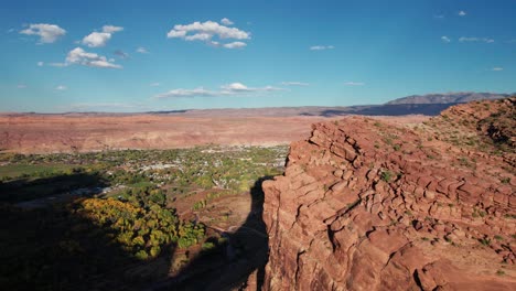 drone aerial shot revealing the entire city of moab, utah on a sunny day