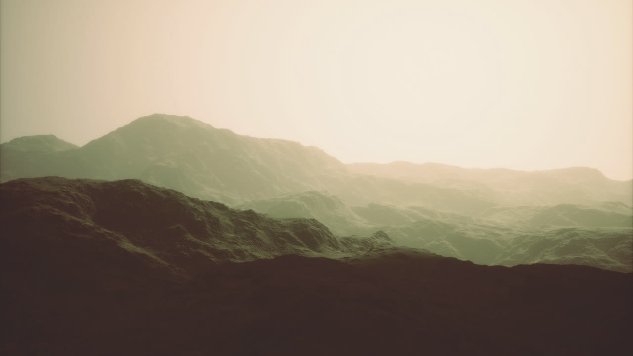 Sunset over rolling hills with soft light illuminating the landscape