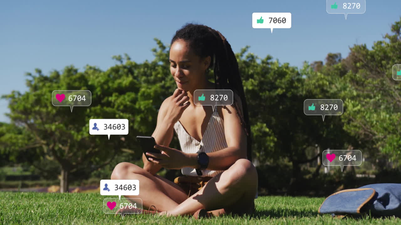 Sitting on grass and using smartphone, woman surrounded by social media likes animation