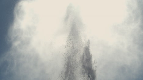 slow motion sea spray bursts upward, creating dramatic plumes in the air under clear daylight