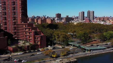 drone shot following traffic up the jfk drive on the harlem river in manhattan, nyc