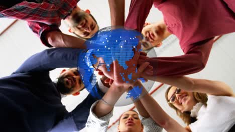 animation of rotating globe over group of diverse business team holding hands