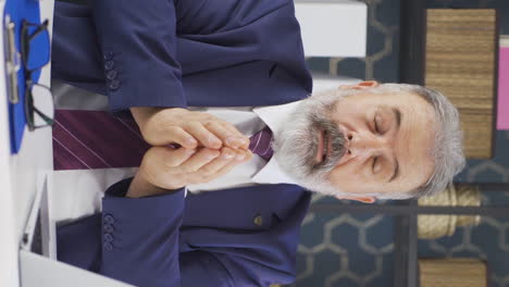 Vertical-video-of-Sick-old-businessman-sneezing.