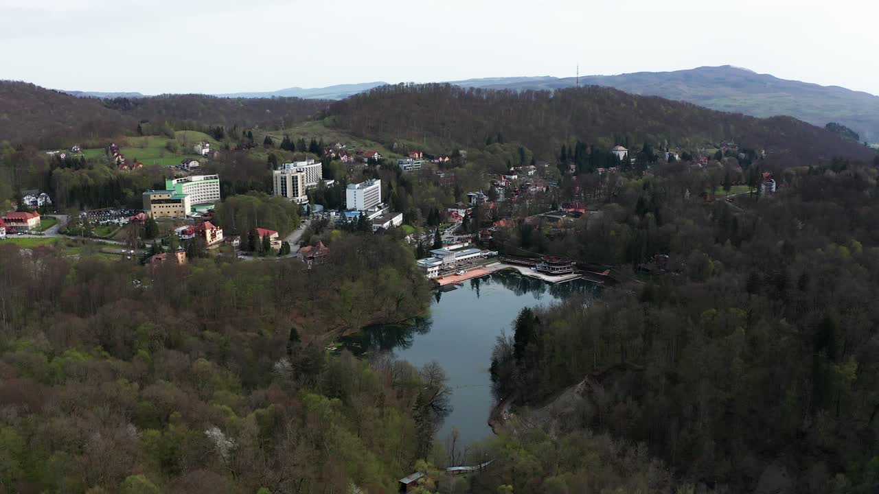 Aerial forward over Ursu lake and surrounding landscape, Sovata. Romania
