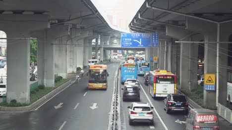 busy city street under overpass