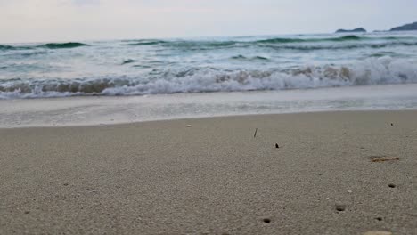 Closeup-Of-Waves-Splashing-On-The-Sandy-Shoreline,-Paradise-Beach,-Thassos-Island,-Greece