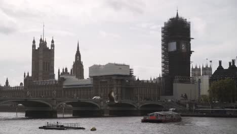 houses of parliament in london with big ben under scaffolding