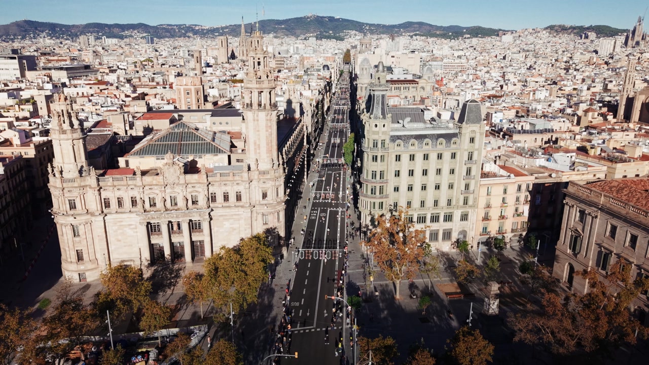 Drone orbit over Via Laietana Barcelona showing historic buildings and city skyline
