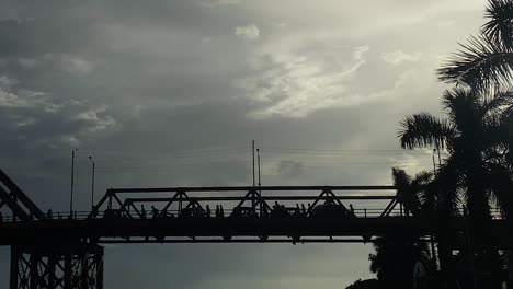 pedestrian people and vehicles passing a bridge