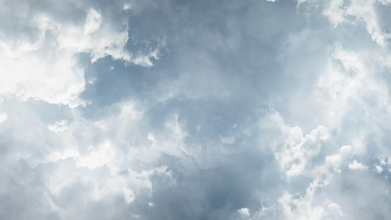 bright white clouds moving in the blue sky
