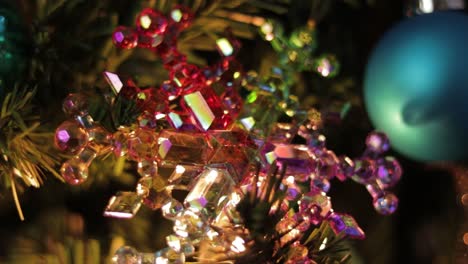 multicolored crystal snowflake ornament on decorated christmast tree