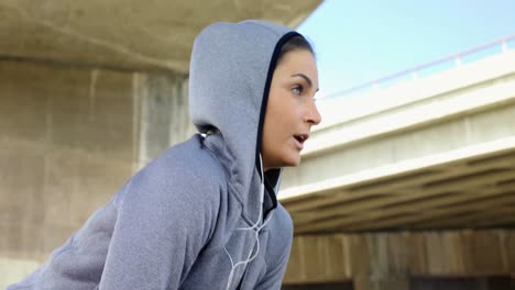 woman listening to music while jogging 4k