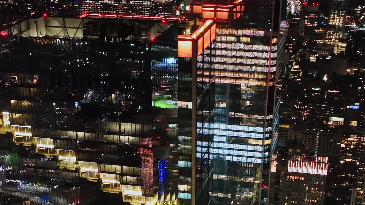 Nighttime aerial view of New York City showcasing bright city lights