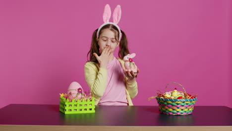 Young-schoolgirl-blowing-air-kisses-in-front-of-camera