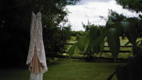 gorgeous reveal of a designer fashion wedding dress in the middle of the fenced back yard at the strathmere wedding resort and spa in ottawa, ontario, canada