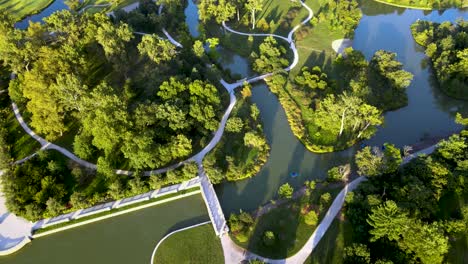 green park with beautiful landscaping paths - ponds - aerial drone overhead