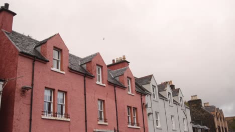 colorful row homes in the seaside village of portree on the isle of skye, highlands of scotland