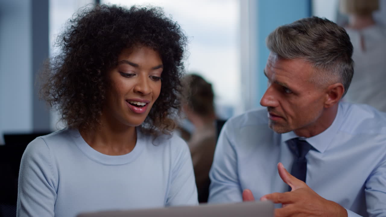 Multiethnic colleagues discussing business plans in office. Two managers working