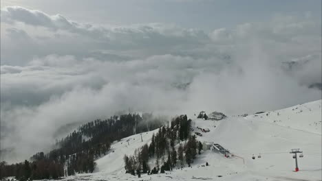 bird's eye view of a snowy valley with a cable car for tourists
