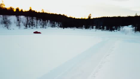 sports car is driving on a frozen lake in the arctic circle