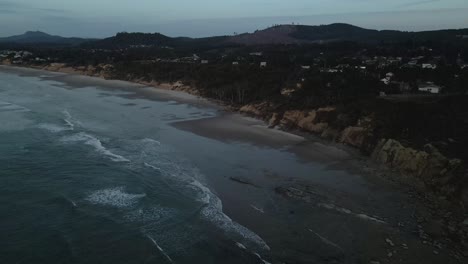drone shot of the yaquina head lighthouse beach in the early morning in newport, oregon