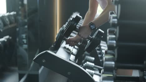 Woman lifting dumbbells in a gym