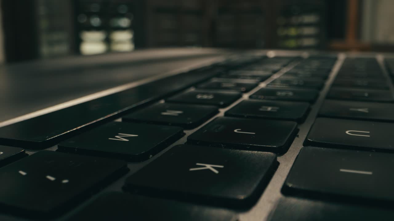 Closeup of hands typing on a laptop, showcasing productivity and advanced technology in a modern workspace