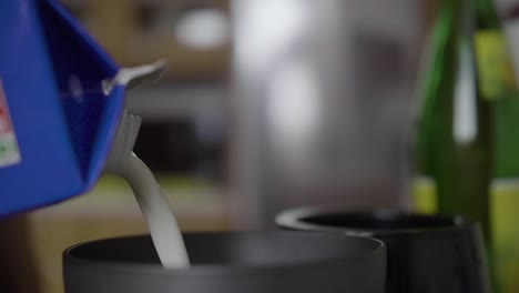 [SLOW-MOTION]-close-shot-of-someone-pouring-milk-into-a-milk-frother-in-the-kitchen