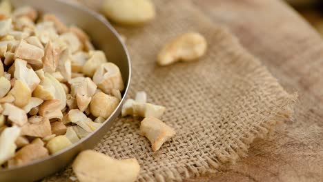 portion of chopped cashew nuts on a rotating plate (seamless loopable)