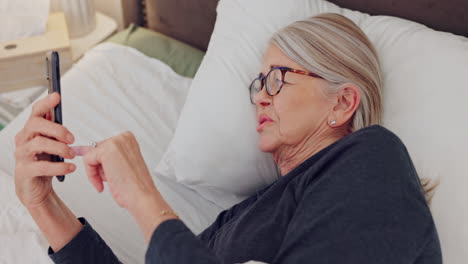 Phone,-relax-and-senior-woman-in-bed-networking