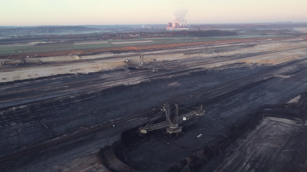 Coal Mine Extraction Site with Power Plant in Background